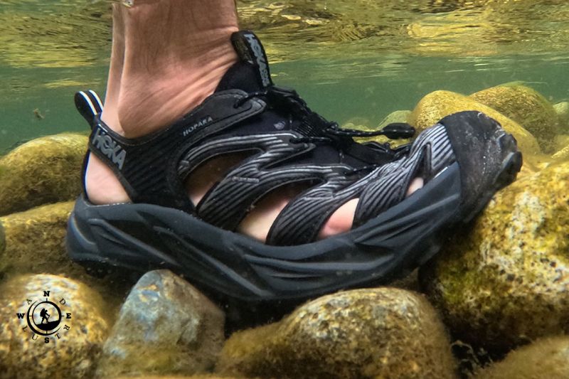 Amphibious shoe with anti-slip sole on a wet rock