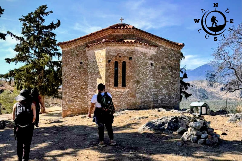 Hikers in front of the chapel of Agios Charalambos on the Ancient Delphi to Kirra trail