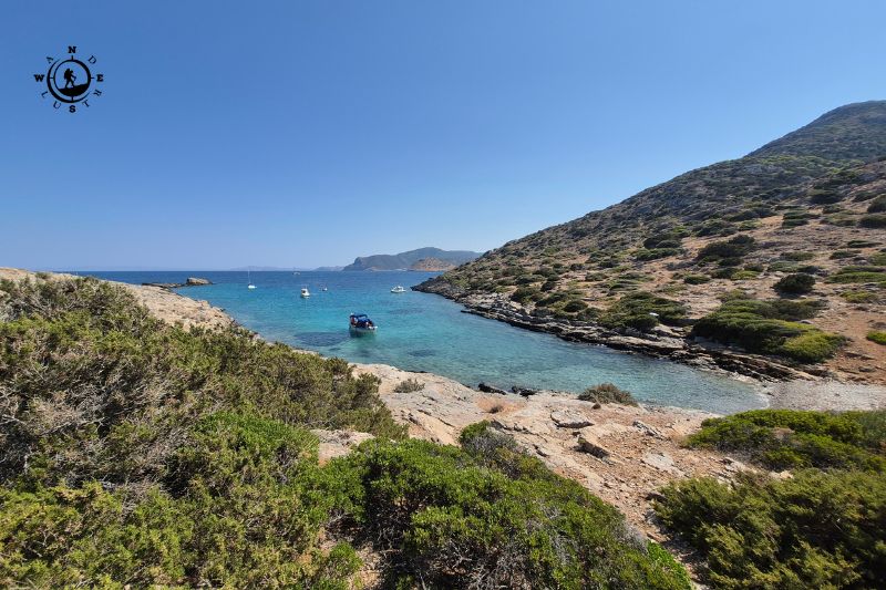 Μικρός βραχώδης όρμος με γαλαζοπράσινα νερά και χαμηλή βλάστηση στους πρόποδες της Περατής