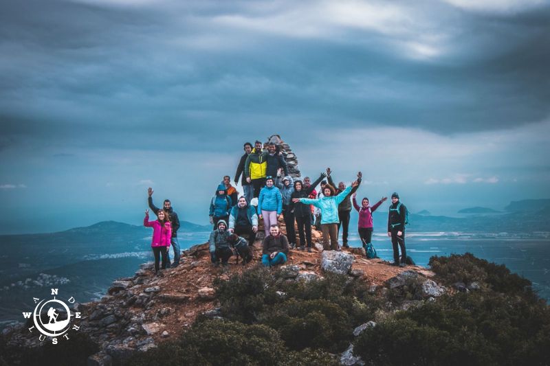 Hiking group celebrating at the summit of Mount Hymettus